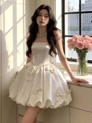Champagne strapless satin bubble mini dress with 3D bow trims - full front view sweet lolita fairy dress on model with dark wavy hair