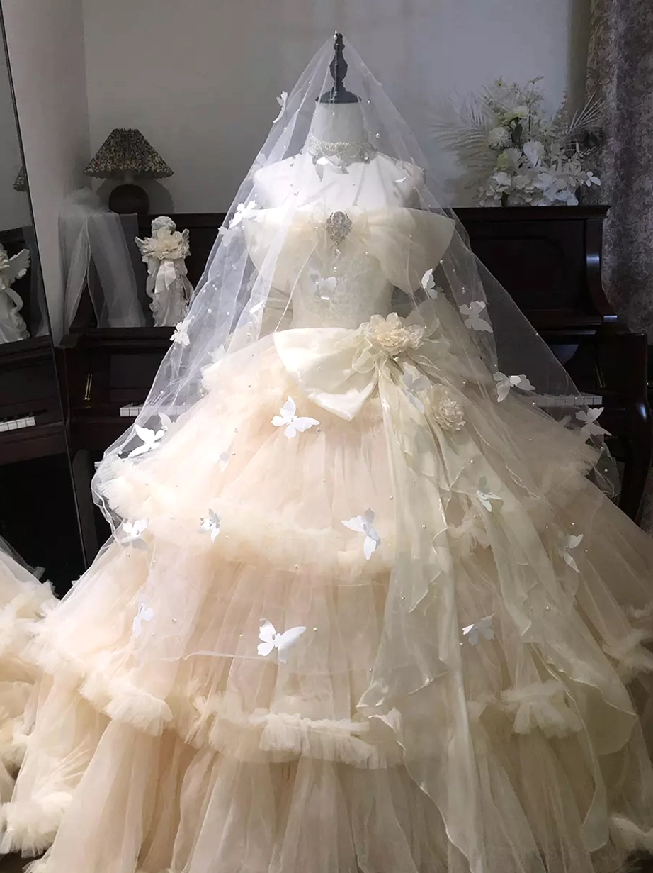 Champagne sweet lolita wedding gown with butterfly veil large waist bow and multi-tiered tulle skirt full view