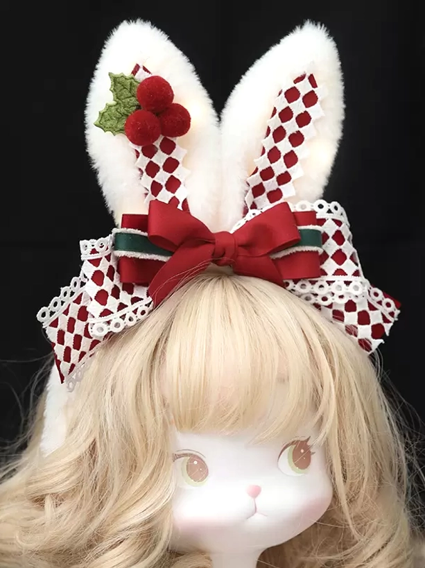 Christmas sweet lolita rabbit ear headband with LED lights front view on blonde curly wig doll head, fluffy white ears with red-white checkered plaid inner lining, lace-trimmed red bow with holly and berry festive decorations