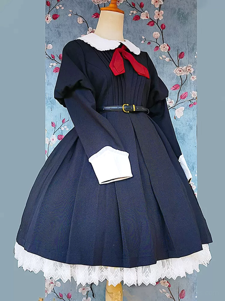 Classic black lolita dress with long puffed sleeves, white Peter Pan collar, red bow, and pleated skirt displayed on dress form with floral backdrop - front three-quarter view showing knotted embellishment details