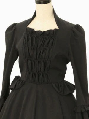 Classic black lolita dress upper body close-up showing square stand collar, ruched front bodice, puffed sleeve construction, and side waist decorative elements