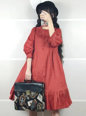Classic linen lolita one-piece dress in deep red with ruffled collar, decorative button placket, and 3/4 puff sleeves, front view on model with black hat