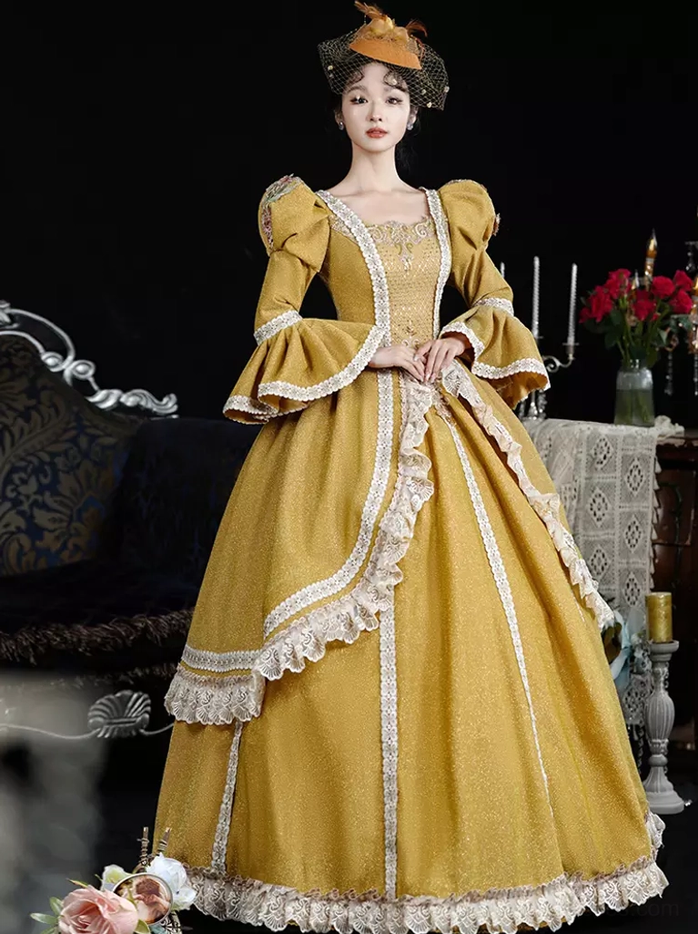 Low front three-quarter view of 18th century inspired classic lolita gown showcasing mustard yellow color, side lace trims, puff bell sleeves, and full length skirt