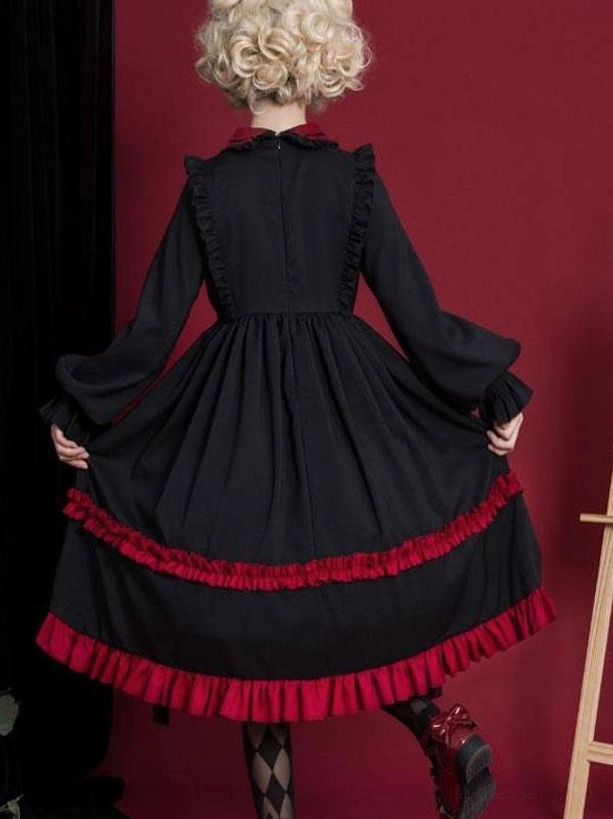 Classic Lolita OP dress worn by model showing full silhouette with ruffled tiers and two-tone color blocking aesthetic