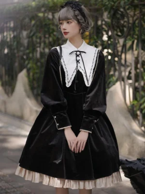 Black velvet classic lolita dress front view with white lace-up doll collar, long puff sleeves, and ruffled beige hem on model wearing dress outdoors
