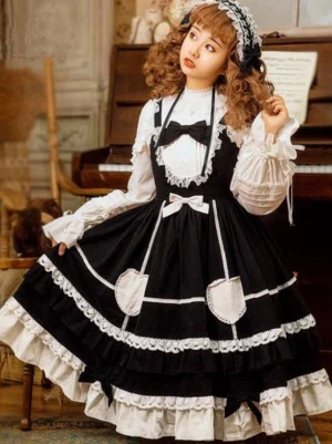 Classic lolita black and white jumper skirt dress with heart pockets and lace trim indoor vintage piano room aesthetic