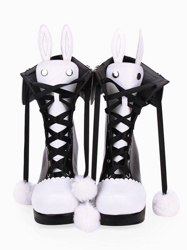 Pair of classic lolita bunny ear chunky heel boots with fluffy pom-pom tassels and sailor-style collar details, overhead flat lay