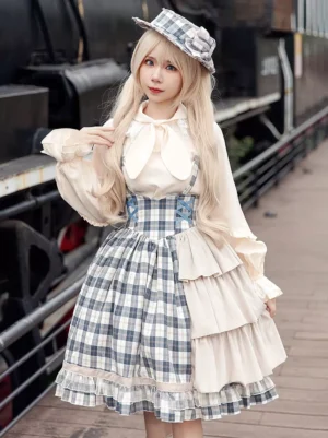 Light sky blue checkered classic lolita jumper dress with tiered ruffles - front full-body model shot on vintage railway platform