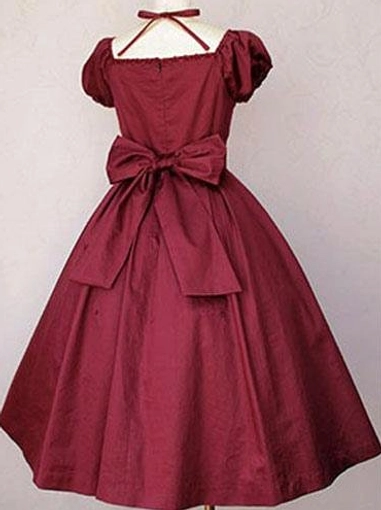 Classic Lolita cotton one-piece dress deep wine red back view displaying large decorative waist bow cross halter straps and flared midi skirt silhouette