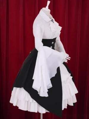 Side profile of black and white tiered gothic lolita dress showing asymmetrical overskirt and layered ruffled underskirt