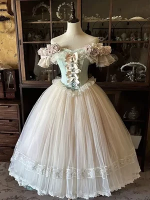 Classic Lolita gown on mannequin featuring corset bodice with ribbon bows, ruffled flower trims, and layered lace-edged tulle skirt in elegant display setting