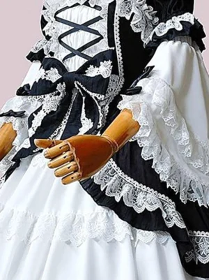 Close-up detail of Classic Lolita dress chest area showing intricate crisscross lacing, layered lace ruffles, and puffed sleeves with delicate lace cuffs