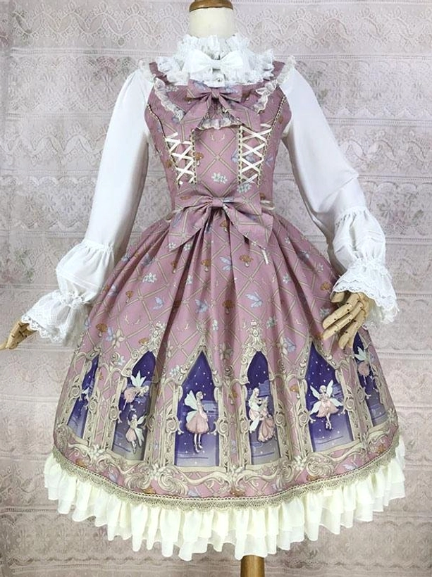 Pink sleeveless classic lolita jumper dress with lace-up front waist bow cathedral fairy print cream ruffled hem three-quarter front view