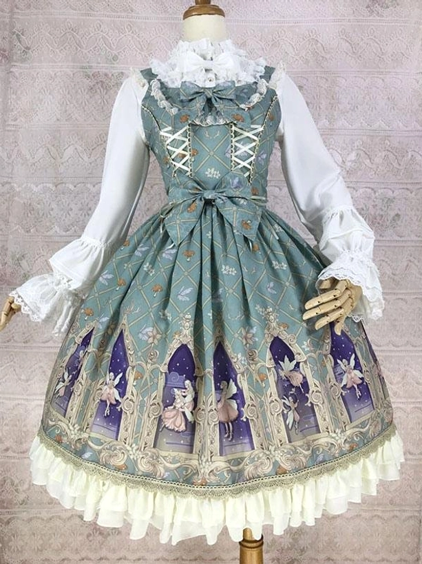 Sage green sleeveless classic lolita jumper dress with lace-up bodice waist bow and cathedral fairy print cream ruffled hem front three-quarter view