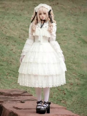 Full front view of white lolita dress featuring multiple tiered lace layers and square neckline displayed on stone platform