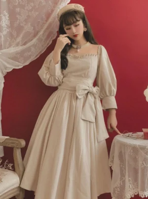 Classic lolita ecru OP dress with ruffled square neckline and puff sleeves front view partial angle vintage aesthetic