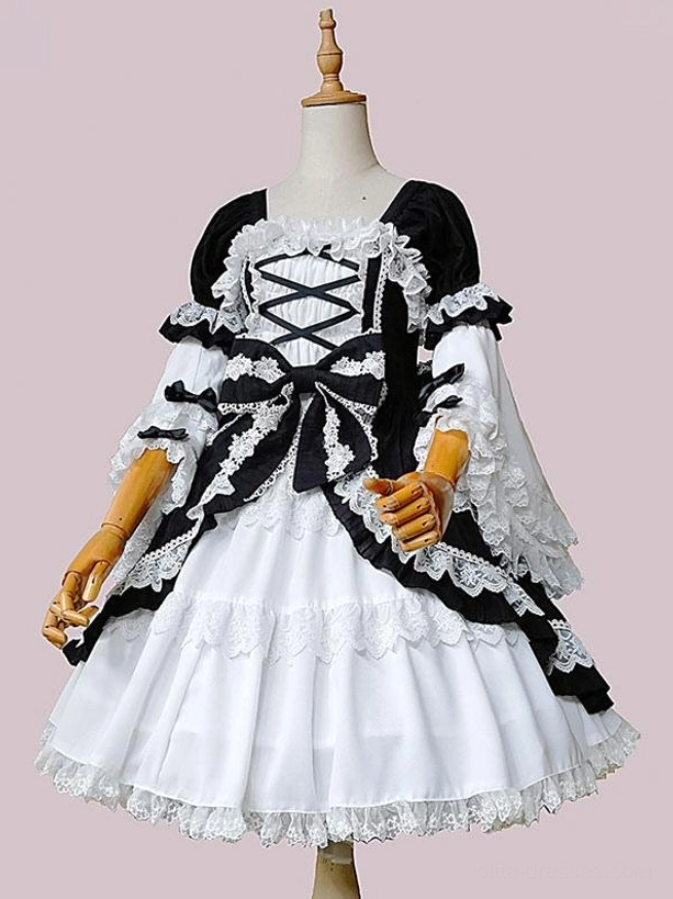 Full front view of Classic Lolita black and white one-piece dress featuring tiered ruffled skirt with lace hem, full-length lace-trimmed sleeves, and elegant silhouette