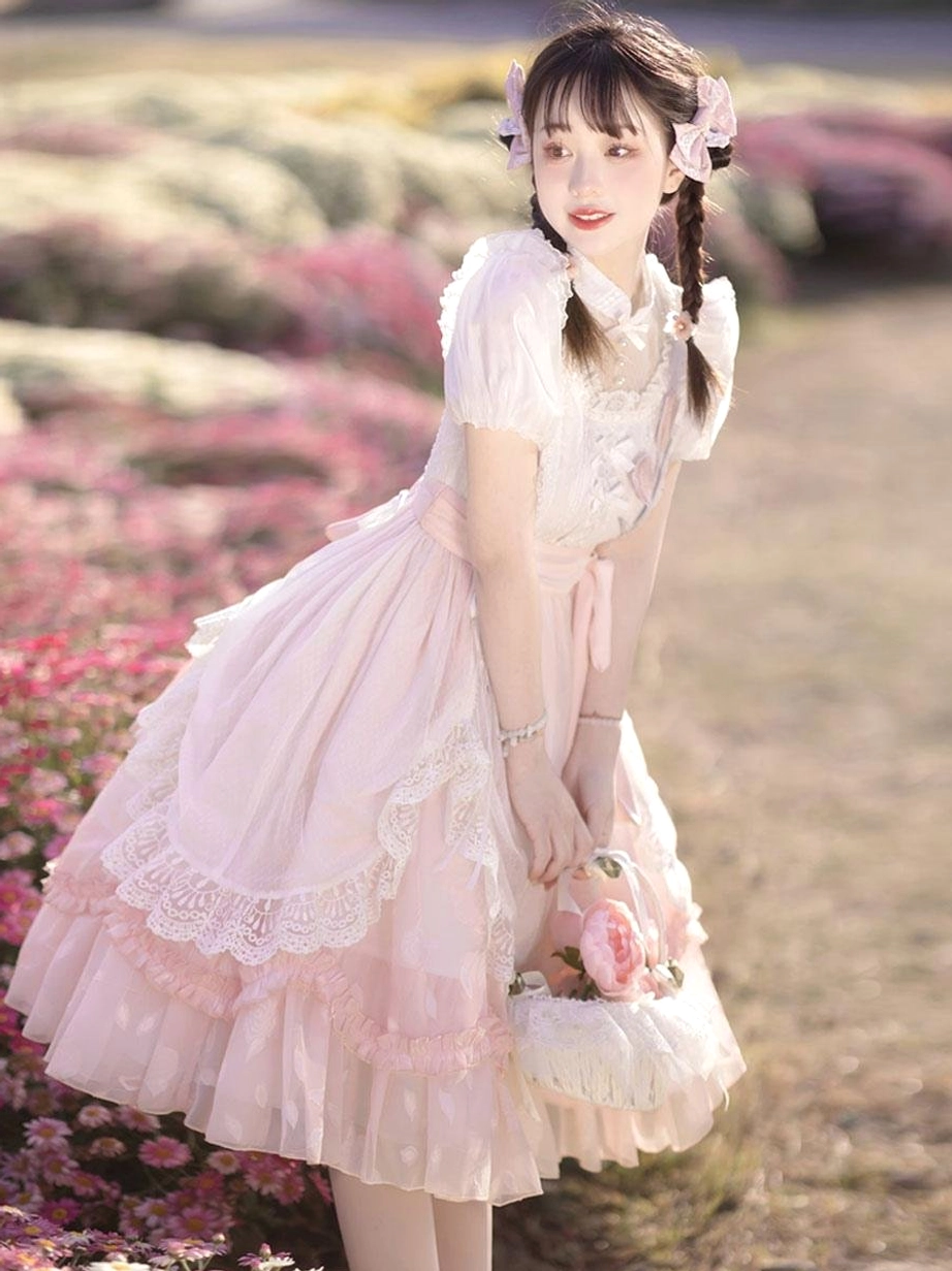 Pink classical lolita dress back three-quarter view holding flower basket lace trim skirt hem outdoor field