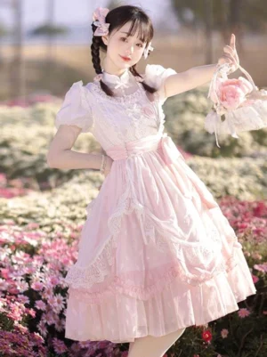 Pink classic lolita dress front three-quarter view with puff short sleeves lace trim tiered ruffled skirt floral embroidery outdoor flower field