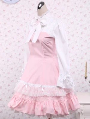 Three-quarter front angle view of pink and white classic lolita cotton dress displaying flared white lace-trimmed cuffs, decorative neck bow ornament, and high collar detail on dress form