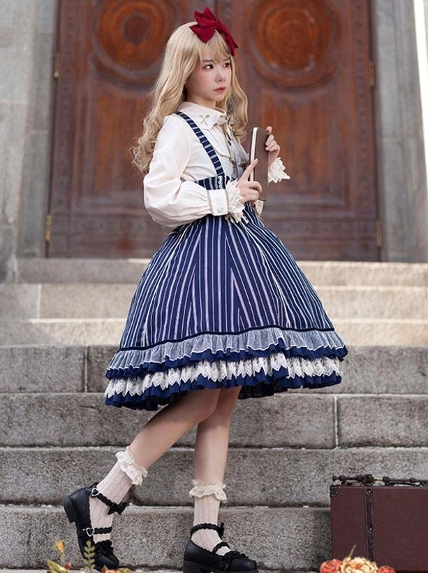 Striped classic lolita dress with white ruffled blouse side three-quarter view on stairs, showing dark blue vertical stripes and mary jane shoes