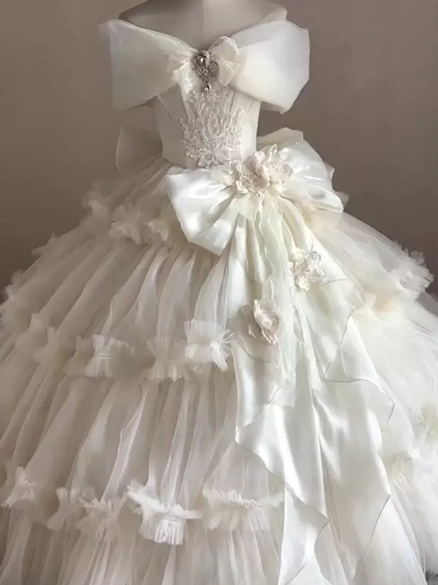 Classic Lolita wedding dress three-quarter view featuring waist satin bow with 3D flowers and tiered ruffled tulle skirt
