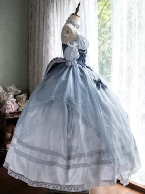 Side front angle of dusty blue classic lolita wedding dress showcasing layered tulle skirt with striped lace hem and off-shoulder silhouette