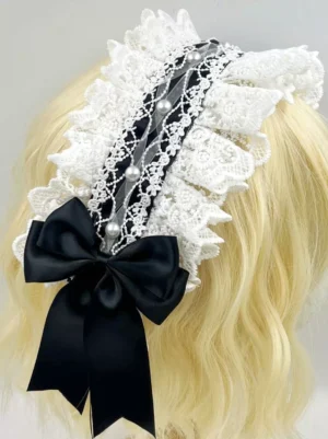 White and black ruffled lace bow hairband with pearl trims worn on blonde long curly wig mannequin, back view showing intricate lace layering, black satin bow, classic lolita headdress style