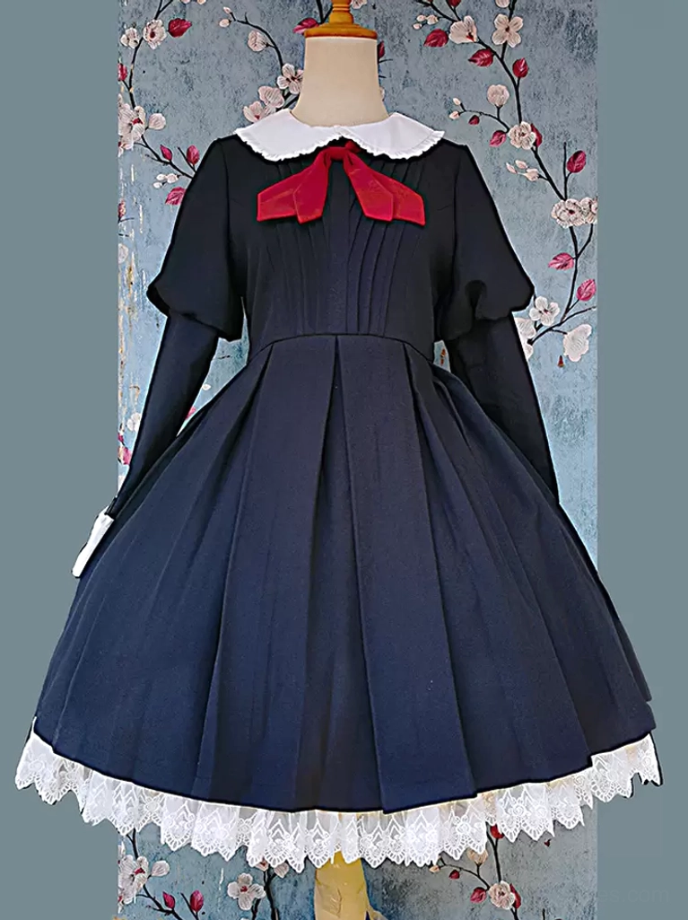 Left side three-quarter view of classic long-sleeve black lolita dress highlighting dark fabric, white structured collar, red bow, and tiered lace hemline with pleated details