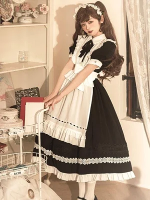 Maid lolita dress three-quarter side view short puff sleeves dotted apron trim ruffled skirt hem indoor shelf background