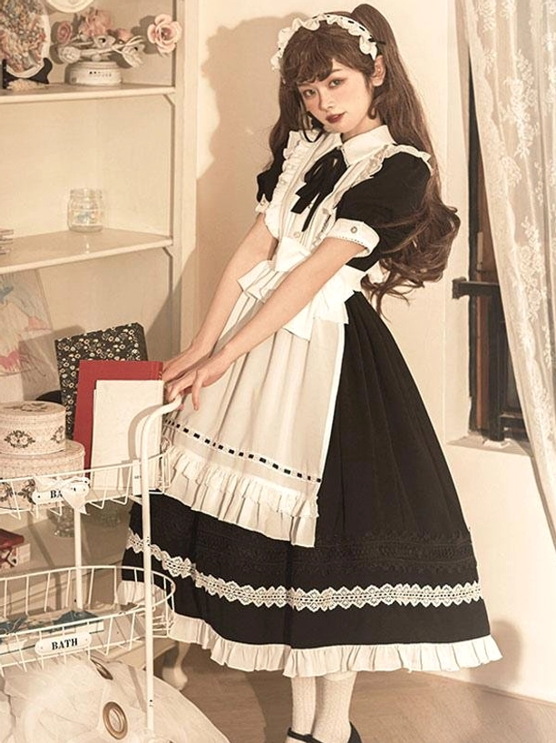 Maid lolita dress three-quarter side view short puff sleeves dotted apron trim ruffled skirt hem indoor shelf background