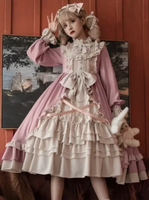 Classical Lolita dress full front standing view two-tone pink white tiered ruffled skirt large front bow long sleeves