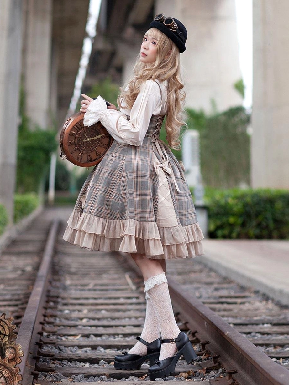 Classical Lolita JSK dress back three-quarter view on blonde model in railway setting, featuring simple elegant silhouette with ruffled skirt hem