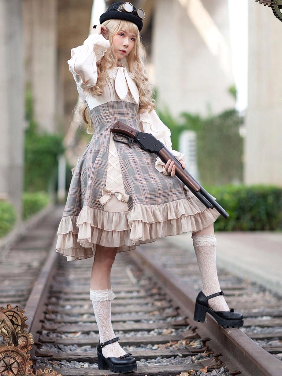 Classical Lolita jumper skirt outfit side three-quarter view with model holding decorative prop on railway setting, showcasing ruffled skirt trim