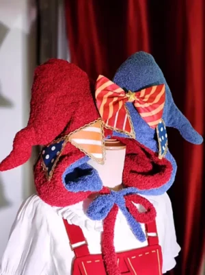 Clown sweet Lolita hat with dual-tone fuzzy plush fabric and striped bow displayed on dress form with red velvet backdrop front three-quarter view