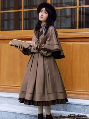 Academic gothic lolita dress in coffee brown with ruffled hem, lantern sleeves, and cape coat worn with retro hat and vintage accessories at outdoor wooden location