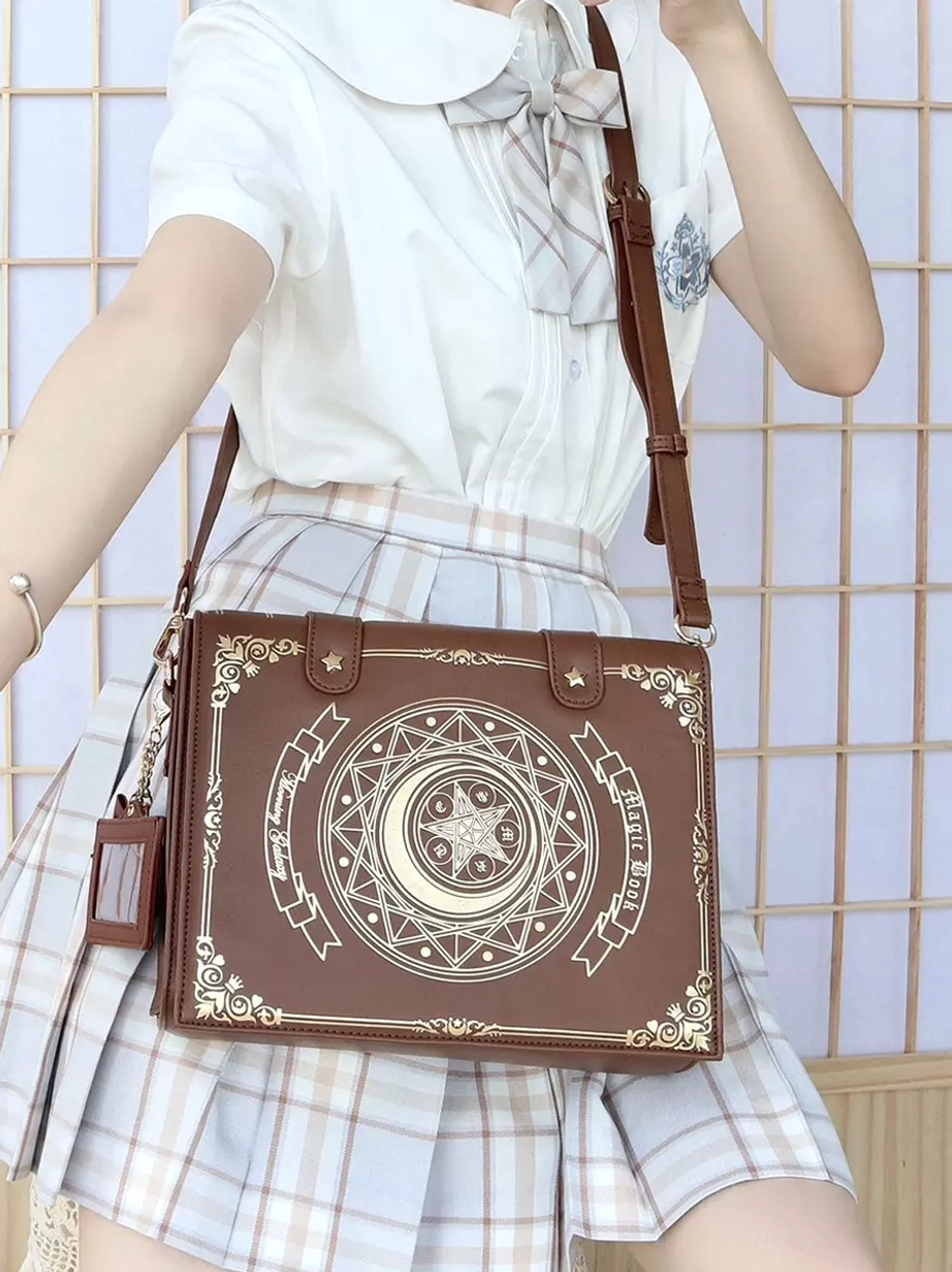 Coffee brown Gothic Lolita school bag worn crossbody style with JK school uniform, front view showing celestial print and authentic Japanese subculture fashion