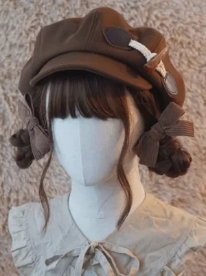 Left-front three-quarter angle of coffee brown lolita newsboy cap showing toggle buckle detail and ribbon bow on mannequin with braided hairstyle