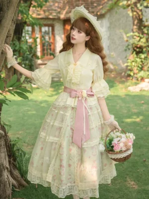 Sweet lolita dress set frontal view with cream floral print pink accents tiered lace skirt model wearing in outdoor garden