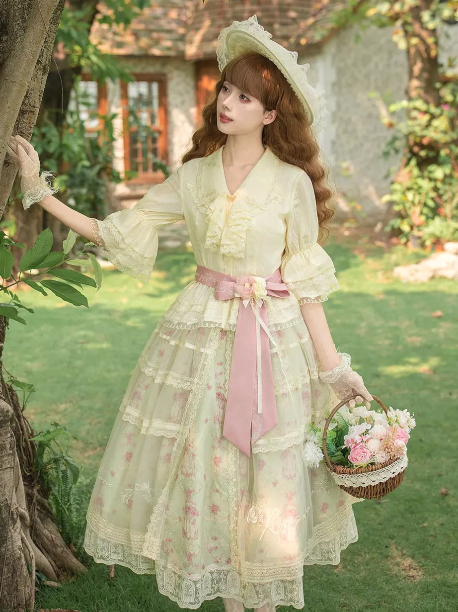 Sweet lolita dress set frontal view with cream floral print pink accents tiered lace skirt model wearing in outdoor garden