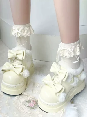 Sweet lolita cream platform snow boots worn on model with white lace-trimmed socks, front view showing fur lining and bow details