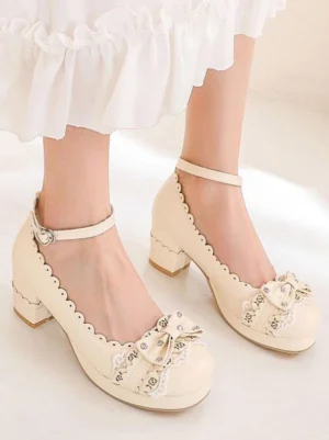 Cream white Lolita chunky heel shoes featuring floral bow decor and scalloped collar side low-angle view worn with white ruffled skirt