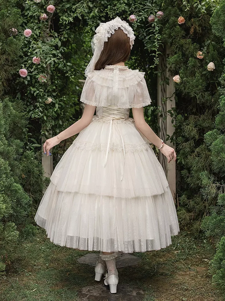Full back view of cream white Lolita dress featuring back lace yoke, multi-tiered tulle skirt, elegant construction, and veil headpiece in rose garden outdoor setting