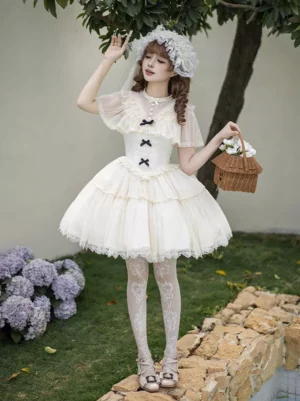 Full front view of cream white puffy princess lolita dress featuring short mesh sleeves, structured corset bodice, lace-hemmed tiered tulle mini skirt, and matching lace flower headdress with model holding decorative basket