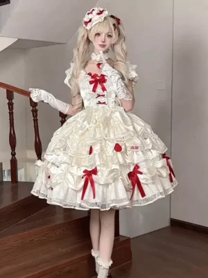 Cream white sweet lolita mini dress with red bows and 3D strawberry decorations, full-body front view on blonde model wearing twin-tail hairstyle, tiered ruffled skirt with lace details, puff sleeves, corset front lacing, indoor wooden staircase backdrop