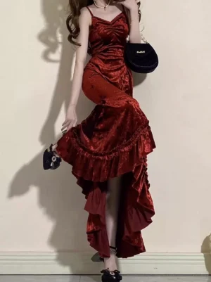 Crimson fishtail Gothic Lolita dress with sweetheart neckline and ruffled high-low hem, left three-quarter view showing fitted velvet bodice