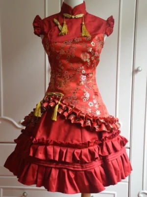 Red plum blossom classic lolita jumper dress with cascading ruffles and golden tassel embellishments full front view on dress form