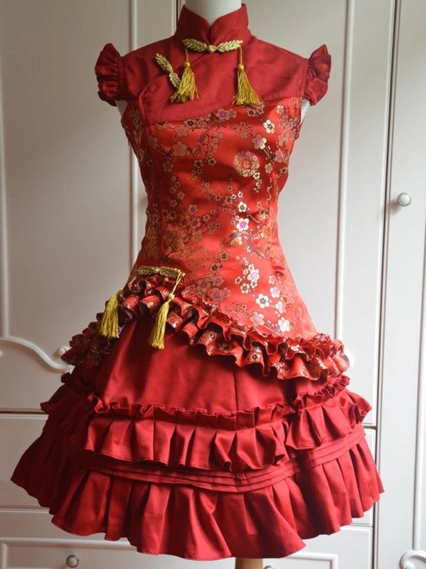 Red plum blossom classic lolita jumper dress with cascading ruffles and golden tassel embellishments full front view on dress form