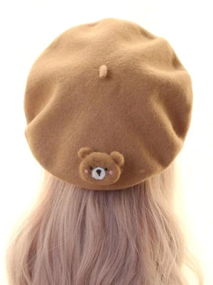 Lolita wool beret back view showing teddy bear ornament and cross-stitch detail on mannequin camel brown color