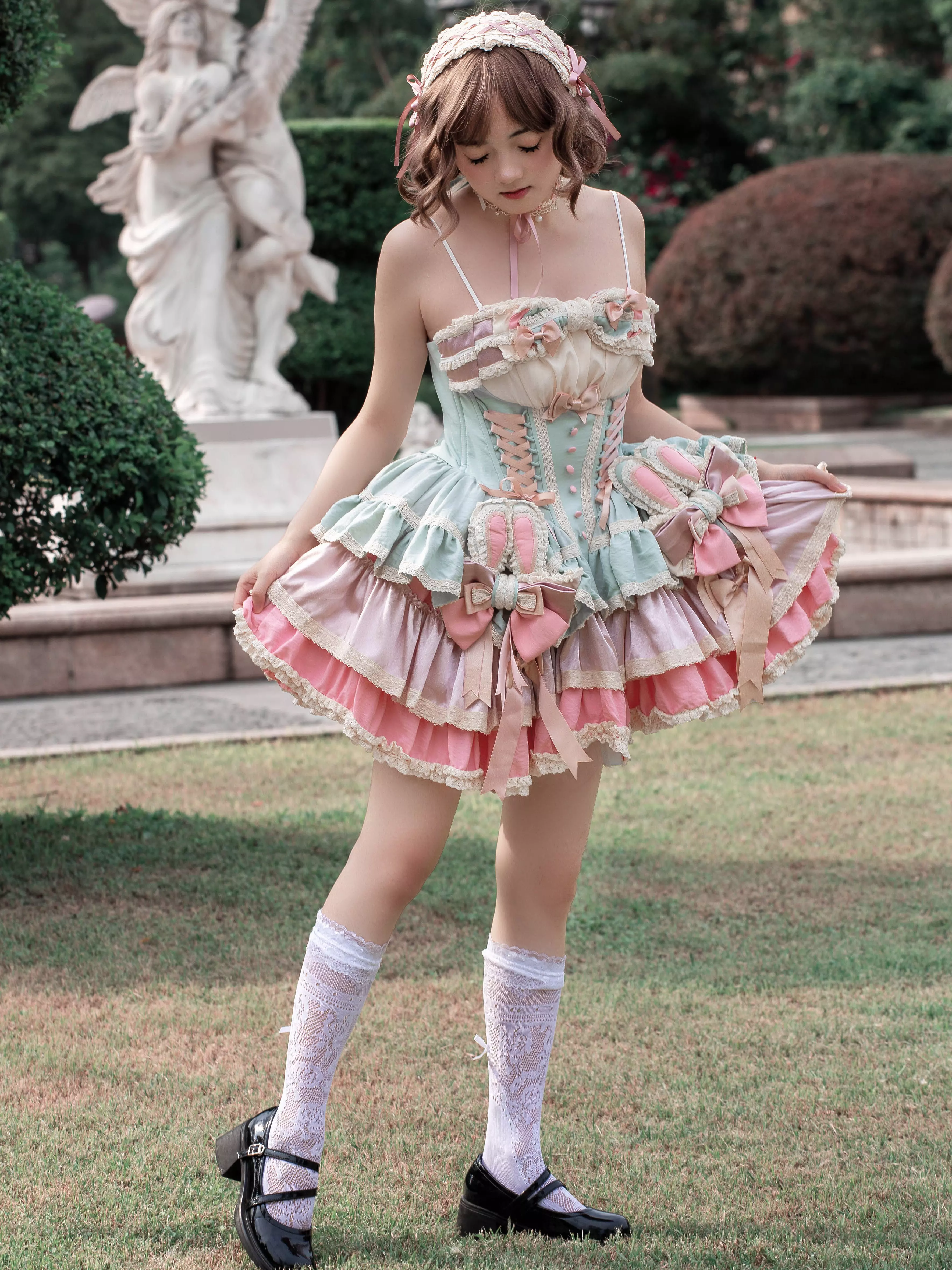 Sweet lolita bunny ear fairy dress detail shot showing satin bow embellishment multi-layer ruffles and color-block pastel design